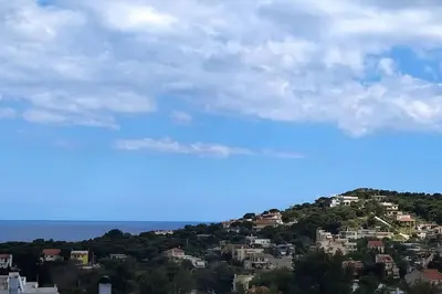 a rainbow in the sky over a city at The Artemis House Project in Artemida