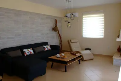 a living room with a couch and a coffee table at The Artemis House Project in Artemida
