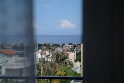 a view of a city from a window at The Artemis House Project in Artemida