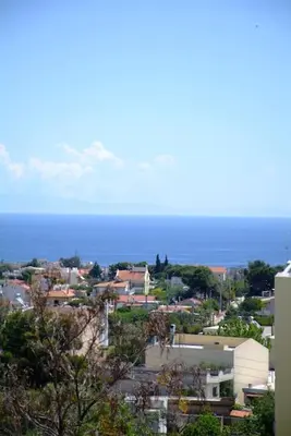 a view of a city with the ocean in the background at The Artemis House Project in Artemida