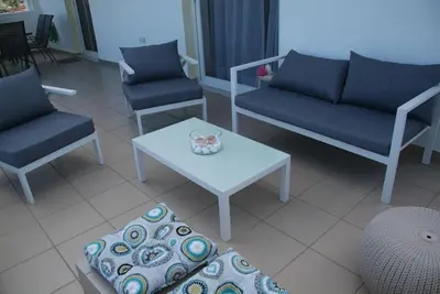 a living room with a couch and a table and chairs at The Artemis House Project in Artemida