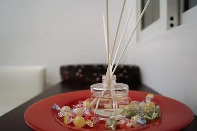 a red plate with a glass jar filled with beads at Platinum Central Apartment in Athens