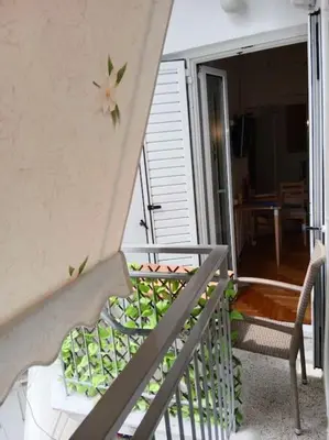 a balcony with a table and chairs on a porch at Platinum Central Apartment in Athens