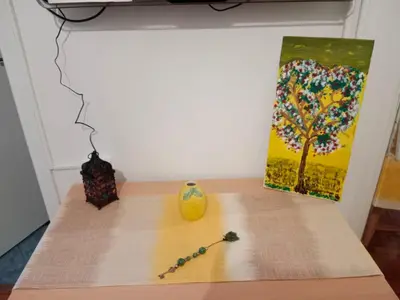 a table with a painting and a vase on it at Platinum Central Apartment in Athens