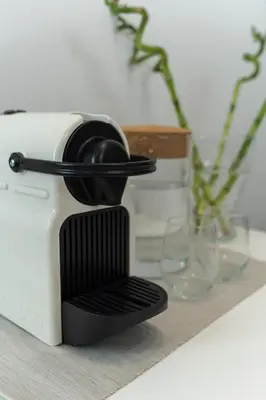a toaster sitting on a table next to glasses at Executive Apartment in Kolonaki in Athens