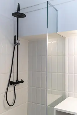 a shower with a glass door in a bathroom at Executive Apartment in Kolonaki in Athens