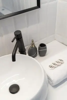 a white sink with a faucet and a towel at Executive Apartment in Kolonaki in Athens