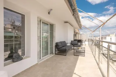 an apartment balcony with a view of the city at Athens Del Sol Suite in Athens