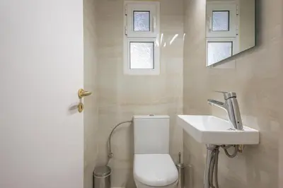 a bathroom with a toilet and a sink at Athens Del Sol Suite in Athens