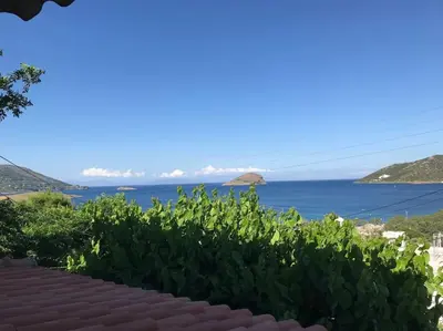 a view of the ocean from a house at The Captain's Penthouse in Porto Rafti