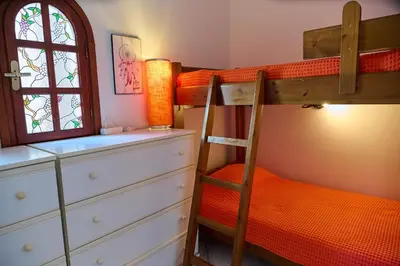 a bedroom with two bunk beds and a ladder at The Captain's Penthouse in Porto Rafti