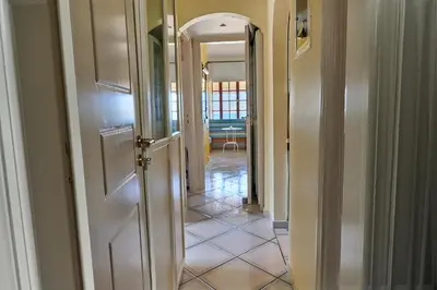 a hallway with an open door leading to a room at The Captain's Penthouse in Porto Rafti