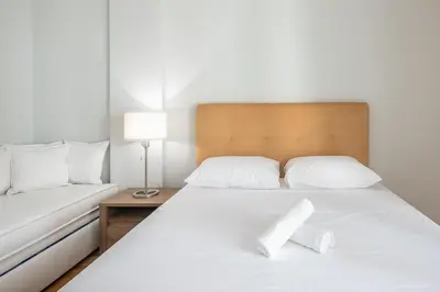 a bedroom with a bed with two white pillows at Victoria Divas Paradise Suite in Athens