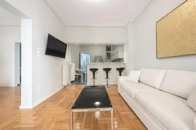 a living room with a white couch and a table at Victoria Divas Paradise Suite in Athens