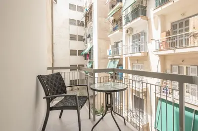 a balcony with a glass table and a chair at Victoria Divas Paradise Suite in Athens