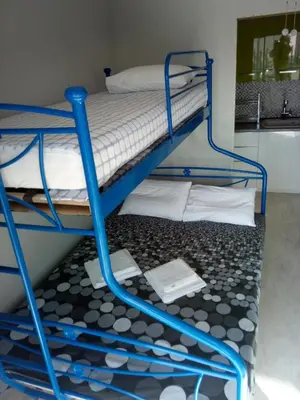 a blue bunk bed in a room with a bathroom at Daisy luxury in Piraeus