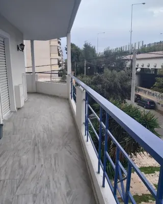 a balcony of a house with a blue railing at Daisy luxury in Piraeus