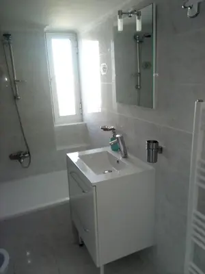 a white bathroom with a sink and a shower at Daisy luxury in Piraeus