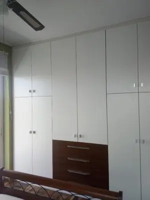 a room with white cabinets and a bench at Daisy luxury in Piraeus