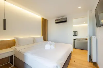 a hotel room with a bed with two towels on it at Earth Boutique Apartments next to Stavros Niarchos in Athens