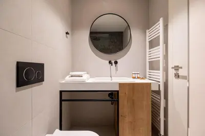 a bathroom with a sink and a mirror at Earth Boutique Apartments next to Stavros Niarchos in Athens