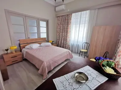 a bedroom with a bed and a table with a bowl on the floor at The Traditional Athenian house for 6, near metro in Athens