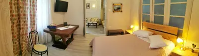 a bedroom with a bed and a desk and a window at The Traditional Athenian house for 6, near metro in Athens