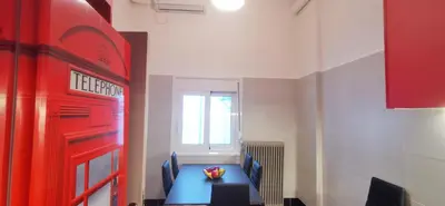 a room with a blue table and chairs and a window at The Traditional Athenian house for 6, near metro in Athens