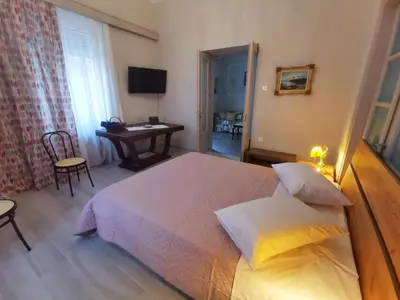 a bedroom with a bed and a table and a desk at The Traditional Athenian house for 6, near metro in Athens