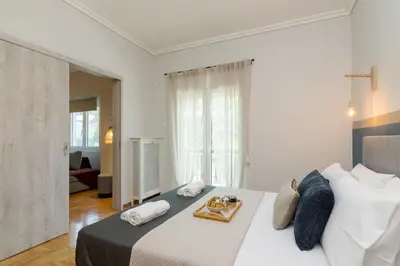 a bedroom with a large bed with a tray on it at Spacious 2 Bedroom Apartment In Koukaki in Athens