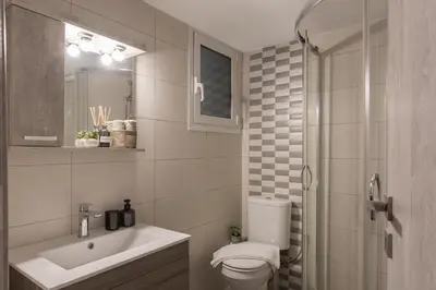 a bathroom with a toilet and a sink and a shower at Spacious 2 Bedroom Apartment In Koukaki in Athens
