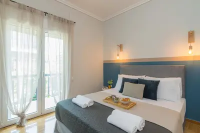 a bedroom with a large bed with a tray on it at Spacious 2 Bedroom Apartment In Koukaki in Athens