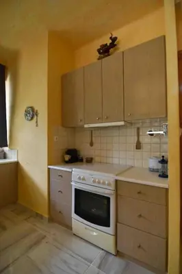 a kitchen with a white stove top oven in it at Agia Marina apartment in Aghia Marina
