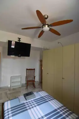 a bedroom with a ceiling fan and a bed at Agia Marina apartment in Aghia Marina