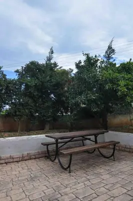 a picnic table and bench on a brick patio at Agia Marina apartment in Aghia Marina