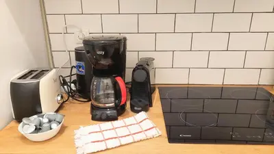 a kitchen counter with a coffee maker and a blender at Cozy apartment in Plaka in Athens