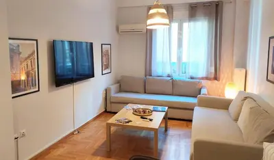a living room with a couch and a table at Cozy apartment in Plaka in Athens