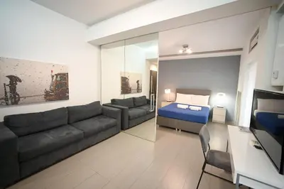 a living room with a couch and a bed at Kolonaki Comfort, Walk to Metro, Plaka & Syntagma in Athens