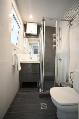a bathroom with a shower and a toilet and a sink at Kolonaki Comfort, Walk to Metro, Plaka & Syntagma in Athens