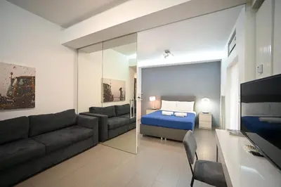 a living room with a couch and a bed at Kolonaki Comfort, Walk to Metro, Plaka & Syntagma in Athens