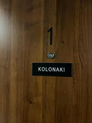 a sign on a wooden door with the number on it at Kolonaki Comfort, Walk to Metro, Plaka & Syntagma in Athens
