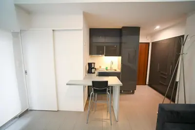 a kitchen with a white table and chairs in a room at Kolonaki Comfort, Walk to Metro, Plaka & Syntagma in Athens