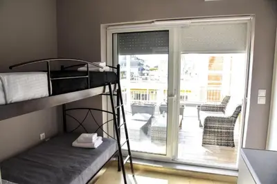 a bunk bed in a room with a balcony at Athens Tiny rooftop by Super Host Hub in Athens