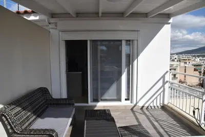 a balcony with a bench and a view of a city at Athens Tiny rooftop by Super Host Hub in Athens