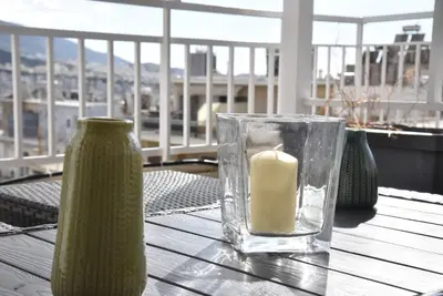 a candle in a glass vase on a table at Athens Tiny rooftop by Super Host Hub in Athens