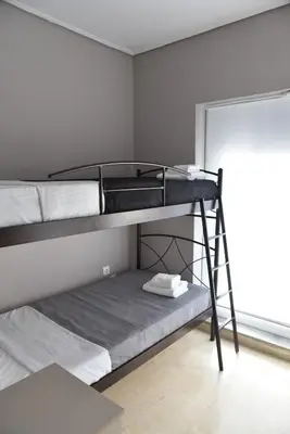 two bunk beds in a room with a window at Athens Tiny rooftop by Super Host Hub in Athens