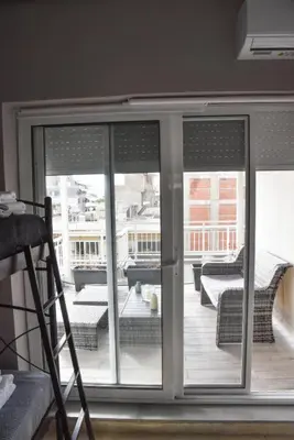 a room with a sliding glass door with a balcony at Athens Tiny rooftop by Super Host Hub in Athens
