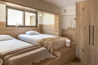 a bedroom with two beds and a window at Casa Meraki by A&D Properties in Porto Rafti