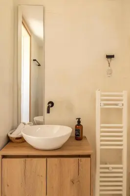 a bathroom with a white sink and a mirror at Casa Meraki by A&D Properties in Porto Rafti
