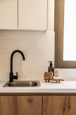 a kitchen sink with a faucet and a counter top at Casa Meraki by A&D Properties in Porto Rafti